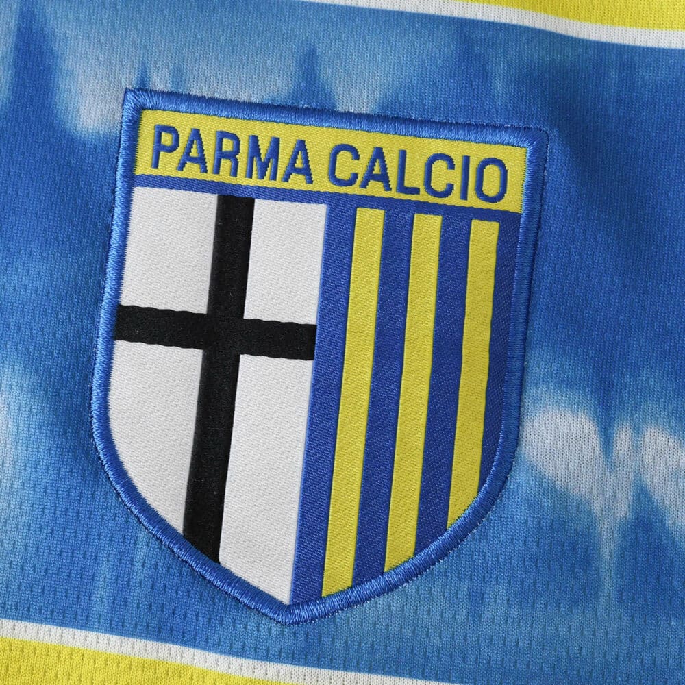 Parma Away 2025/26 Fan Version badge with blue, yellow, and black Parma Calcio crest on fabric.