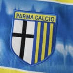 Parma Away 2025/26 Fan Version badge with blue, yellow, and black Parma Calcio crest on fabric.