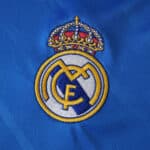 Embroidered Real Madrid crest on blue fabric, Third Kit 2025/26 Fan Version.