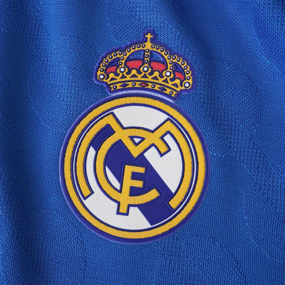 Real Madrid crest on blue 2025/26 Third Player Version jersey fabric.