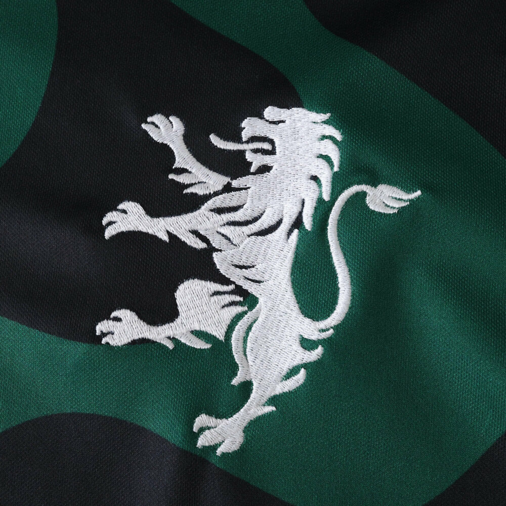 Close-up of Sporting CP Third 2025/26 Fan Version jersey featuring embroidered white lion crest.