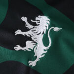 Close-up of Sporting CP Third 2025/26 Fan Version jersey featuring embroidered white lion crest.