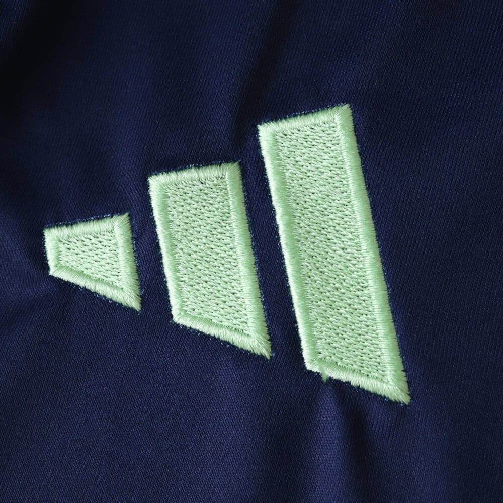 Close-up of the embroidered Adidas logo on the Ajax Away 2025/26 Fan Version jersey.