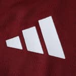Close-up of the Aston Villa 2025/26 home player version jersey showing a white Adidas logo on claret fabric.