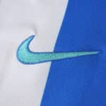 Close-up of the Nike logo on the Brighton & Hove Albion 2025/26 home fan version jersey fabric.