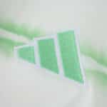 Close-up of the Celtic Third 2025/26 Fan Version jersey featuring a green geometric logo on light fabric.