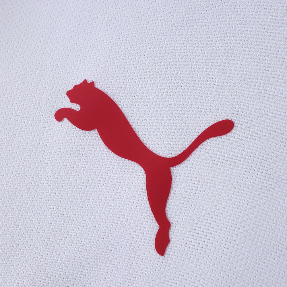 Close-up of red Puma logo on the white fabric of the Galatasaray Away 2025/26 Fan Version jersey.