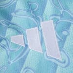 Close-up of the Adidas logo on the 2025/26 Juventus Away Fan Version jersey in blue and white.