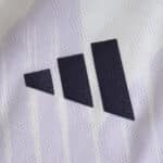 Close-up of the Adidas logo on the Manchester United 2025/26 away player version jersey.