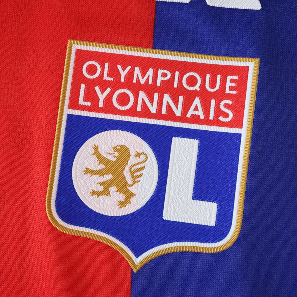 Olympique Lyonnais 2025/26 Home Player Version jersey badge on red and blue fabric.