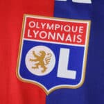 Olympique Lyonnais 2025/26 Home Player Version jersey badge on red and blue fabric.