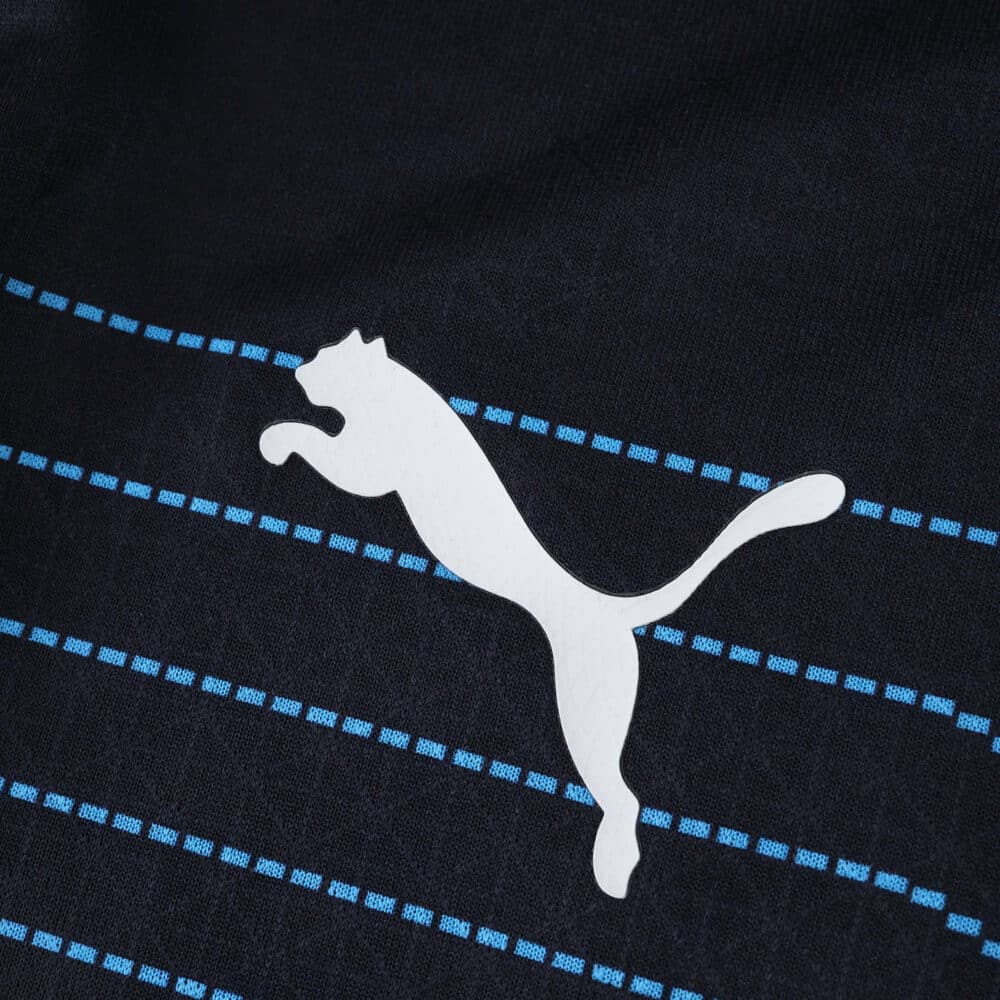 Close-up of Puma logo on the Olympique Marseille 2025/26 away player jersey with blue stripes.