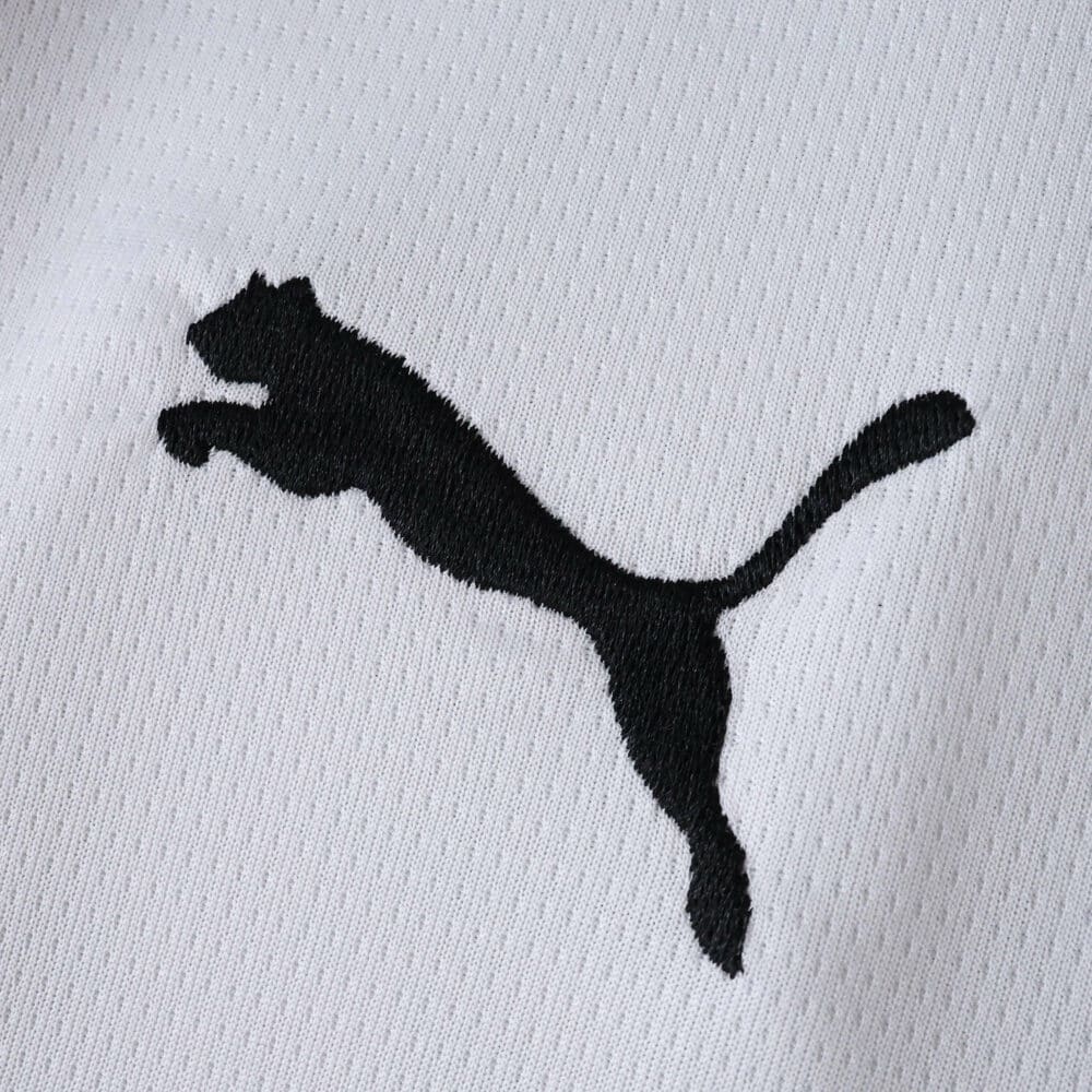 Close-up of the black Puma logo on the 2025/26 Parma Home Fan Version jersey fabric.