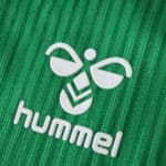 Close-up of the Hummel logo on the green Real Betis 2025/26 Player Version home jersey fabric.