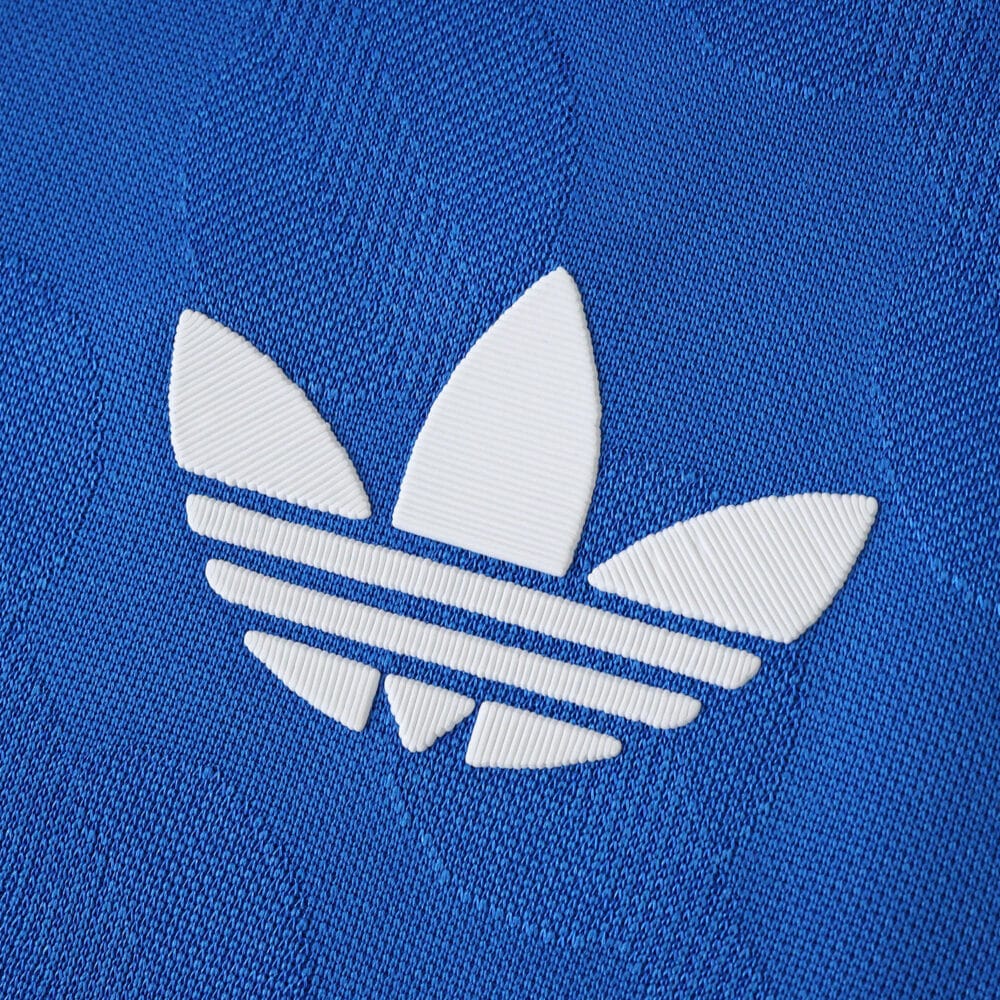Close-up of the white Adidas Trefoil logo on the blue Real Madrid Third 2025/26 Player Version jersey.
