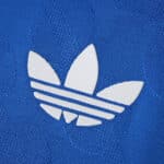 Close-up of the white Adidas Trefoil logo on the blue Real Madrid Third 2025/26 Player Version jersey.