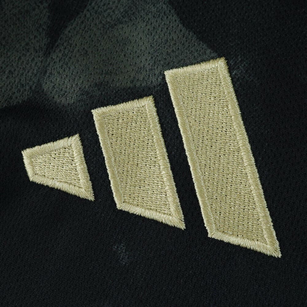 Close-up of the gold Adidas logo on the Union Berlin Away 2025/26 Fan Version jersey.