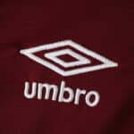 Close-up of the white Umbro logo on the maroon West Ham United 2025/26 Home Fan Version jersey fabric.