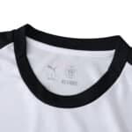Close-up of AC Milan Away 2025/26 Fan Version jersey collar with black trim and Puma logo.