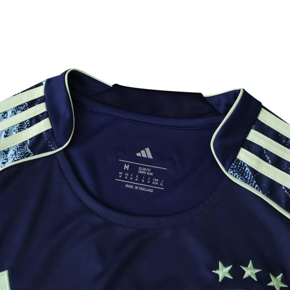 Collar and shoulder detail of Ajax Away 2025/26 Fan Version jersey with three white stars and Adidas stripes.