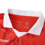 Close-up of Braga Home 2025/26 Fan Version jersey collar in red with a white trim and Puma logo inside.