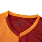 Close-up of the Galatasaray 2025/26 Home Fan Version jersey collar in red and yellow with Puma logo.