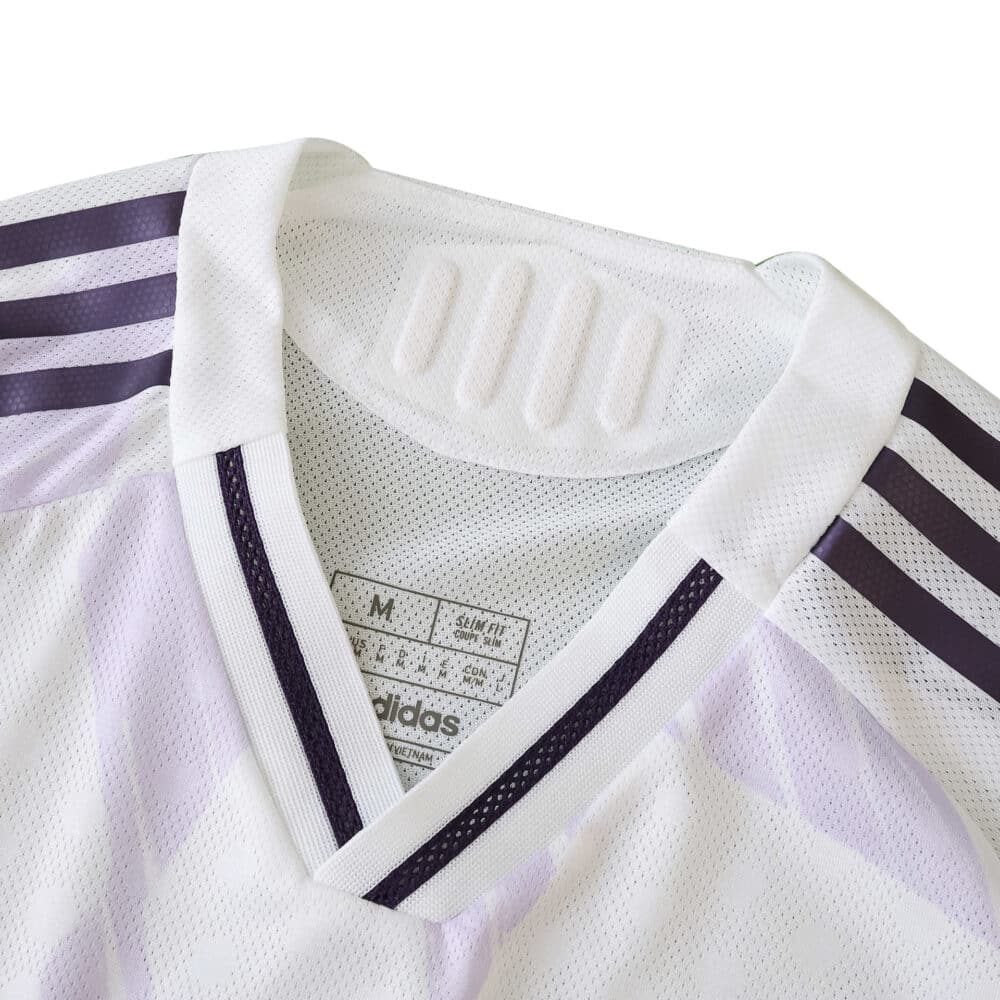 Close-up of the 2025/26 Manchester United away player jersey collar and Adidas logo detailing.