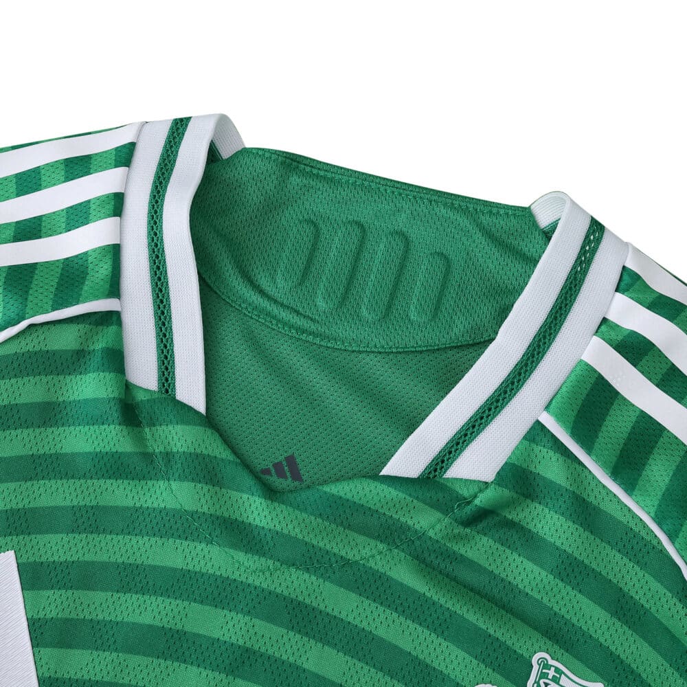 Close-up of Newcastle United 2025/26 away player version jersey collar in green with white stripes.