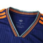 Close-up of Newcastle United Third 2025/26 Fan Version collar with orange and teal striped details.