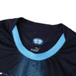 Close-up of Olympique Marseille 2025/26 Away Player Version jersey collar with club and Puma logos.