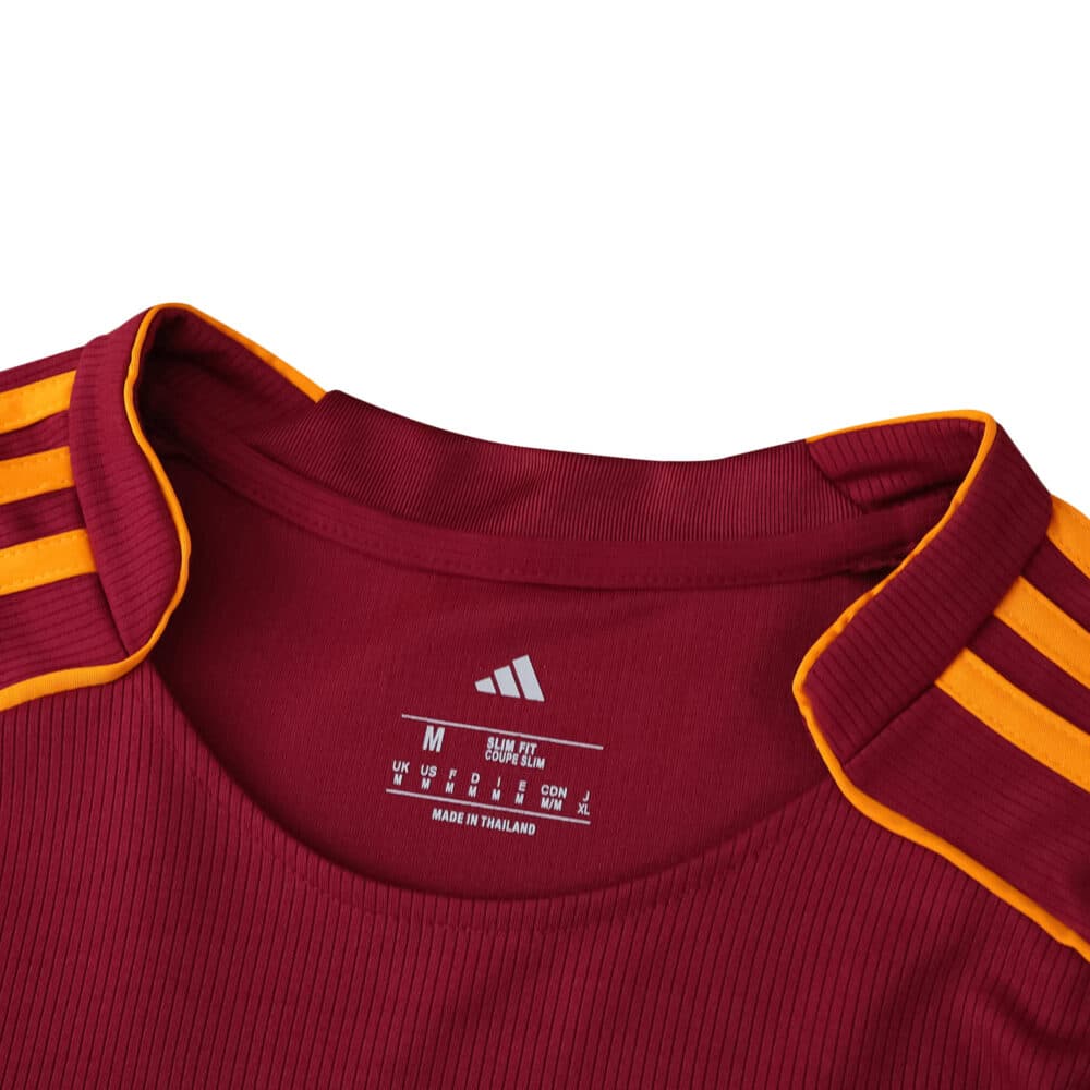 Close-up of the Roma 2025/26 home fan jersey collar with yellow stripes on a red background.