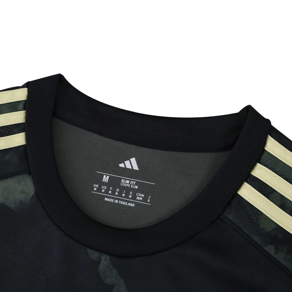 Close-up of Union Berlin Away 2025/26 Fan Version jersey collar with gold Adidas stripes on shoulders.