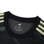Close-up of Union Berlin Away 2025/26 Fan Version jersey collar with gold Adidas stripes on shoulders.