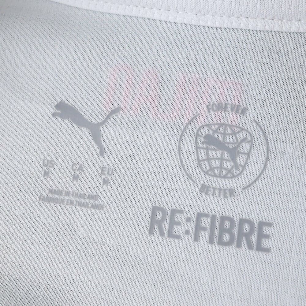 Close-up of the AC Milan Away 2025/26 Fan Version jersey tag showing Puma and Re-Fibre logos.