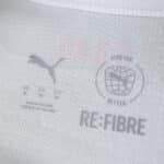 Close-up of the AC Milan Away 2025/26 Fan Version jersey tag showing Puma and Re-Fibre logos.