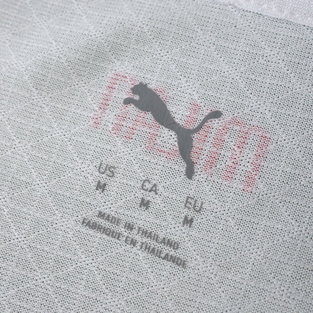 Close-up of AC Milan 2025/26 Away Player Version shirt collar showing Puma logo, sizing, and fabric details.