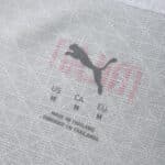Close-up of AC Milan 2025/26 Away Player Version shirt collar showing Puma logo, sizing, and fabric details.