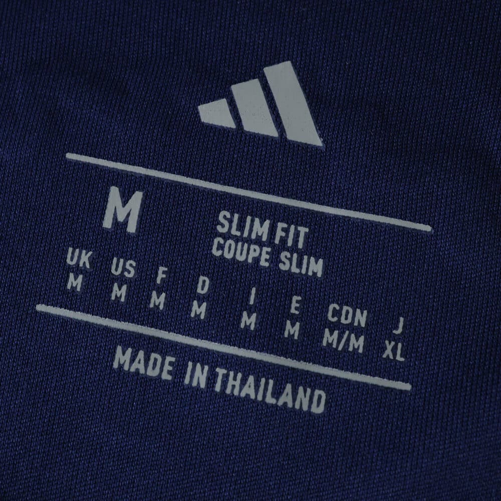 Size label inside Ajax Away 2025/26 Fan Version jersey, showing medium slim fit and made in Thailand.