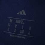 Close-up of the inner collar label on the Ajax Away 2025/26 Player Version jersey, showing size and care details.