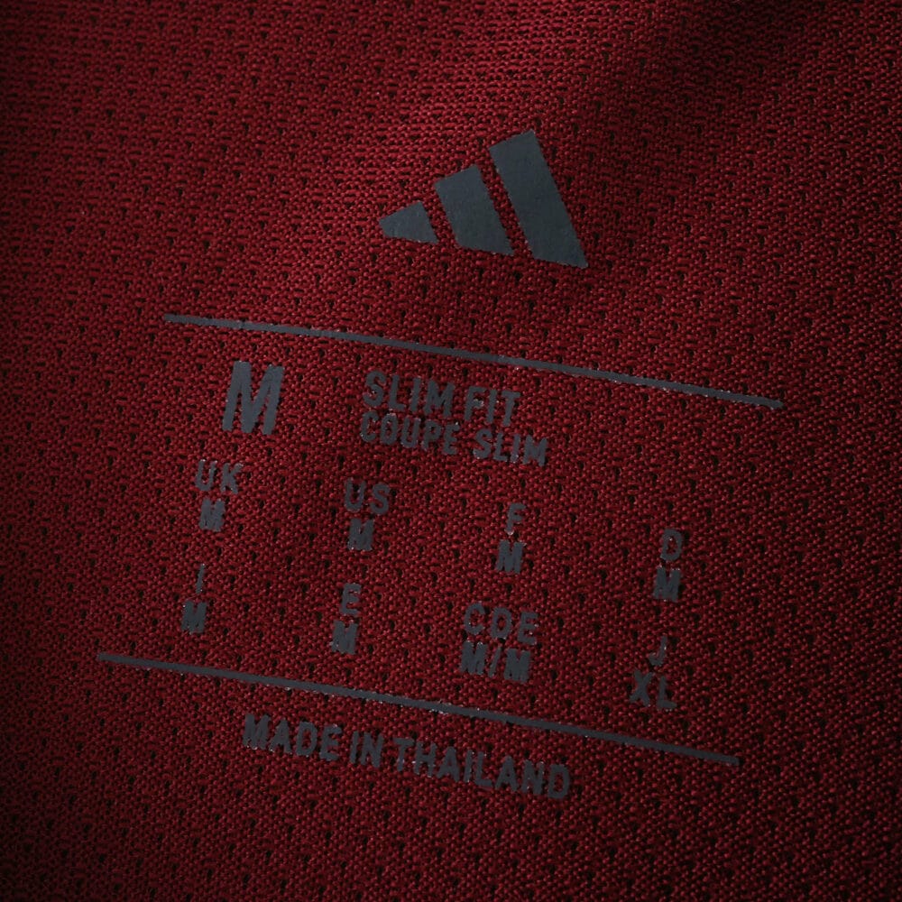 Close-up of the inner label on Aston Villa Home 2025/26 Player Version jersey, showing size and care details.