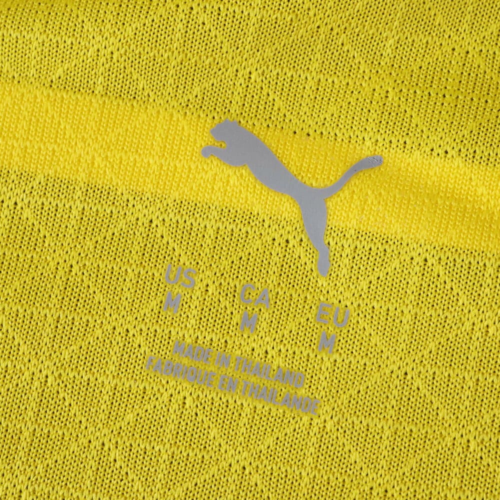 Close-up of Borussia Dortmund 2025/26 Home Player Version jersey fabric with Puma logo and size details.