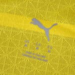 Close-up of Borussia Dortmund 2025/26 Home Player Version jersey fabric with Puma logo and size details.