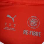 Close-up of Braga Home 2025/26 Fan Version jersey neck label with Puma and RE:FIBRE logos.