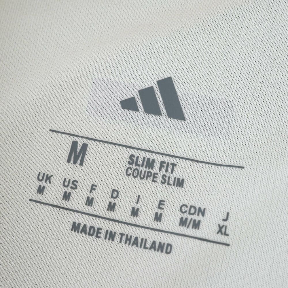 Close-up of the inner label on the Celtic Third 2025/26 Fan Version shirt, showing size and fit details.