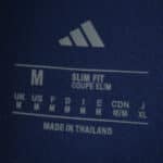 Size label inside Fenerbahce Home 2025/26 Fan Version jersey showing medium, slim fit, made in Thailand.