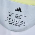 Juventus Away 2025/26 Fan Version collar tag showing size, fit details, and Adidas logo.
