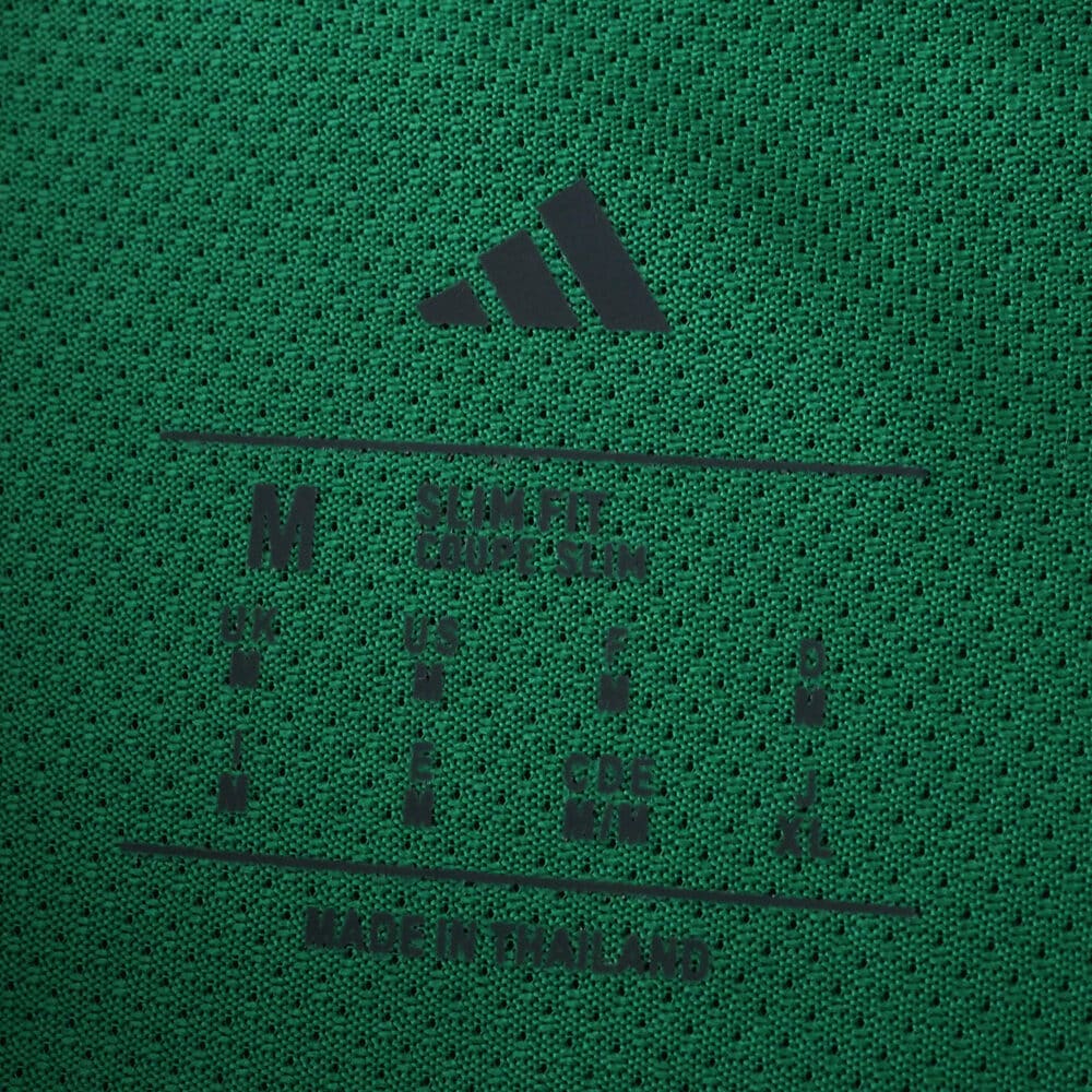 Close-up of the inner collar tag on the green Newcastle United 2025/26 Away Player Version shirt.