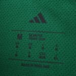 Close-up of the inner collar tag on the green Newcastle United 2025/26 Away Player Version shirt.