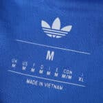 Close-up of the Real Madrid 2025/26 Third Fan Version jersey label showing size M and made in Vietnam.