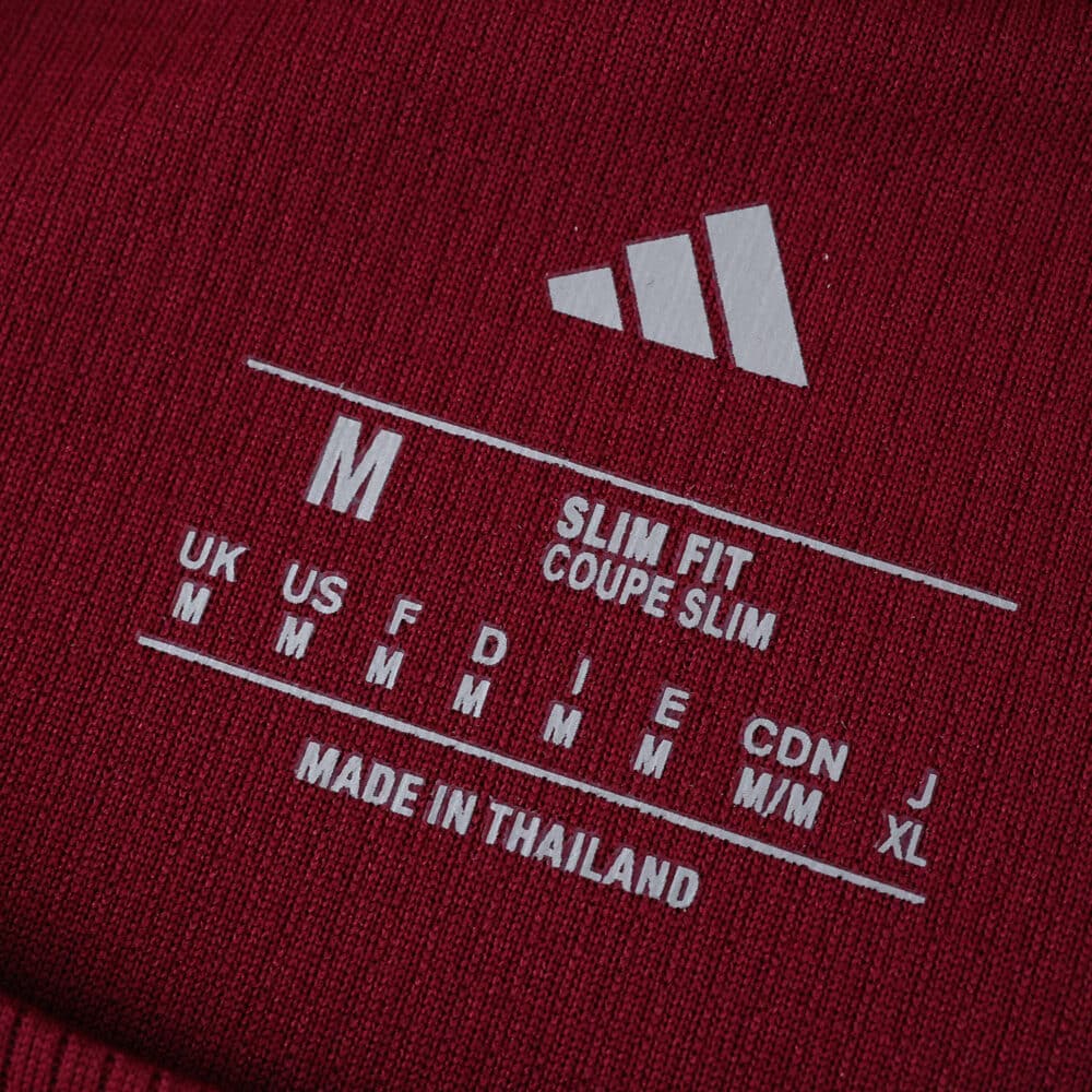 Close-up of Roma Home 2025/26 Fan Version shirt label showing size M, slim fit, made in Thailand.